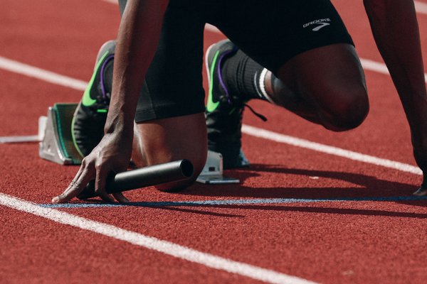 What is the optimal sprinting posture for maximum velocity in track and field?